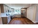 Modern kitchen features stainless steel appliances, light gray cabinets, and subway tile backsplash at 703 Central Nw Dr, Concord, NC 28027