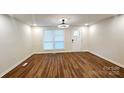 Bright living room features sleek flooring, modern ceiling fan, and lots of natural light at 703 Central Nw Dr, Concord, NC 28027