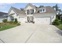 Lovely home with a three-car garage and a classic white exterior at 7150 Irongate Dr, Indian Land, SC 29707