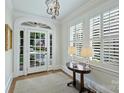 Bright foyer with hardwood floors, white trim, sidelights, and traditional furnishings with ample sunlight at 726 E Kingston Ave, Charlotte, NC 28203