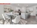 Dining area features a table with seating adjacent to the modern kitchen at 11139 Cardinal Creek Ave, Charlotte, NC 28215