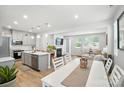 Open-concept kitchen and living area, with modern appliances, a fireplace, and ample seating at 11246 Bartrams Way, Charlotte, NC 28278