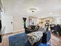 Bright living room featuring hardwood floors, modern lighting, and an open floor plan to the kitchen at 1140 Randall Ct, Concord, NC 28025