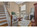 Spacious living room boasts high ceilings, fireplace, large windows, and elegant staircase at 1236 James Farm Rd, Hickory, NC 28602