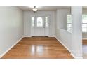 Inviting foyer with a stylish front door and gleaming hardwood floors at 14307 Hartwell Farm Dr, Charlotte, NC 28278