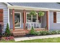 Inviting front porch featuring classic rocking chairs and meticulous landscaping, perfect for relaxation at 1507 Breckenwood Dr, Rock Hill, SC 29732