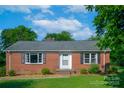 Classic brick ranch home with black shutters, green lawn, and mature trees at 1617 Madison St, Rock Hill, SC 29732