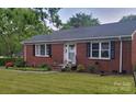 Charming brick ranch home with well-maintained landscaping, and a cozy front porch at 1617 Madison St, Rock Hill, SC 29732