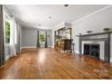 Bright living room featuring hardwood floors, fireplace, and wooden bar with stools at 1617 Madison St, Rock Hill, SC 29732