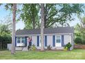 Quaint single story home with a well kept lawn, tasteful landscaping, and patriotic flag at 1744 Emerywood Dr, Charlotte, NC 28210