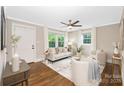 Cozy living room with a ceiling fan, hardwood floors, neutral tones, and plenty of natural light at 1744 Emerywood Dr, Charlotte, NC 28210