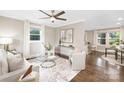 Bright living room featuring hardwood floors, ceiling fan, and an open floor plan at 1744 Emerywood Dr, Charlotte, NC 28210