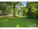 Well-manicured front yard with mature trees and lush green grass surround a two-story house at 204 S Deerfield Cir, Salisbury, NC 28147