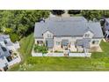 Aerial view of townhouse with a private, fenced backyard patio area and lush green surroundings at 222 Ross Moore Ave, Charlotte, NC 28205