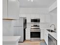 Modern kitchen featuring stainless steel appliances, white cabinets, and a sleek design at 222 Ross Moore Ave, Charlotte, NC 28205