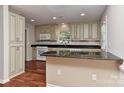 Bright kitchen with custom cabinets, granite counters, and hardwood floors at 2706 Bremer Ct, Charlotte, NC 28210