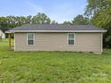 Rear view of a single-story home highlighting its tidy exterior and a well-manicured lawn at 313 S Park Dr, Wadesboro, NC 28170