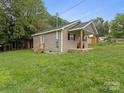 Single-story home with a covered side porch, showcasing the neatly kept yard at 313 S Park Dr, Wadesboro, NC 28170