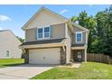 Charming two-story home featuring a two-car garage, landscaped yard, and neutral siding at 329 Brannon Meadows Dr, York, SC 29745