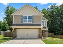 Charming two-story home featuring a two-car garage, landscaped yard, and neutral siding at 329 Brannon Meadows Dr, York, SC 29745