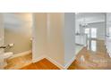 Hallway featuring a half bath, wood floors, and neutral paint at 349 Valley Brook Se Ln, Concord, NC 28025