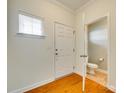 Hallway with wood flooring, a half bath, and a doorway leading to another room at 349 Valley Brook Se Ln, Concord, NC 28025