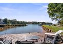 Backyard view of the lake with a wooden deck perfect for lounging and entertaining at 364 Catalina Dr, Mooresville, NC 28117
