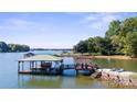 Picturesque covered boat dock with a large deck and entertainment area overlooking the water at 364 Catalina Dr, Mooresville, NC 28117