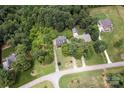 Aerial view of a home nestled among lush trees on a sprawling lot at 3874 Willow Grove Ln, Concord, NC 28025