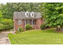 Beautiful brick home showcasing manicured landscaping and charming architectural details at 3874 Willow Grove Ln, Concord, NC 28025