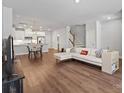 Open-concept living room featuring hardwood floors and modern décor at 517 Morrows Turnout Way, Pineville, NC 28134