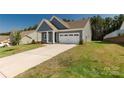 A stunning home with a well-maintained lawn and a spacious driveway leading to a garage at 5244 Admirals Lndg, Lancaster, SC 29720