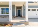 Inviting front porch with stone accents and a stylish dark-colored front door at 5244 Admirals Lndg, Lancaster, SC 29720