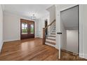 Bright foyer with hardwood floors, stairs, front door, and elegant light fixtures at 537 Riddle Mill Rd, Clover, SC 29710