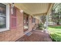 Covered front porch with decorative tile and a porch swing at 617 Oak Grove Rd, Kings Mountain, NC 28086