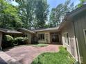 Charming single-story home with a brick driveway and mature trees surrounding the property at 62 Fairway Rdg, Clover, SC 29710
