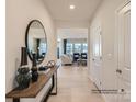 Welcoming foyer featuring light wood floors, stylish console table, decorative mirror, and an open view into the living area at 6346 Fairfax Ct, Maiden, NC 28650