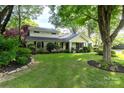 Charming home with a well-maintained lawn, mature trees, and beautiful landscaping at 802 E Franklin St, Monroe, NC 28112