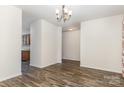 Open dining area featuring wood floors, neutral walls, and a view of the kitchen at 9416 Cotton Gum Rd, Charlotte, NC 28227