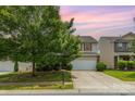 Charming two-story home with a well-manicured lawn and a spacious driveway at 9416 Cotton Gum Rd, Charlotte, NC 28227