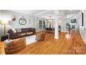Open-concept living room and dining area with hardwood floors and stylish furniture at 126 Blandina Ct, Fort Mill, SC 29708
