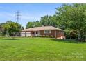 Attractive brick home with manicured front lawn and two-car garage at 128 Howie St, Mount Holly, NC 28120