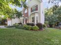 Traditional two-story home with beautiful lawn, red shutters, and front door wreath at 130 Nims Spring Dr, Fort Mill, SC 29715