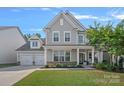 Charming two-story home featuring a two-car garage and landscaped front yard at 1335 Bryson Gap Dr, Fort Mill, SC 29715