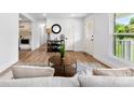 Bright living room with hardwood floors, a cozy rug, and views of the landscaped yard at 1426 Larkfield Ln, Charlotte, NC 28210