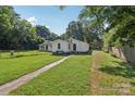 Spacious backyard with a well-manicured lawn and mature trees offering ample privacy at 1626 W Park Ave, Albemarle, NC 28001
