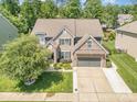 Beautiful home featuring stone accents, a well-manicured lawn, and an attached two-car garage at 183 Canoe Pole Ln, Mooresville, NC 28117
