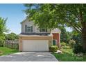 Two-story home featuring neutral siding, updated green shutters and a covered front porch at 1986 Trace Creek Dr, Waxhaw, NC 28173