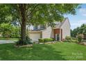 Beautiful two-story home with mature shade tree, manicured lawn, and inviting curb appeal at 1986 Trace Creek Dr, Waxhaw, NC 28173