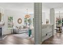 Bright living room with hardwood floors, decorative wood columns, and views into dining room at 1986 Trace Creek Dr, Waxhaw, NC 28173